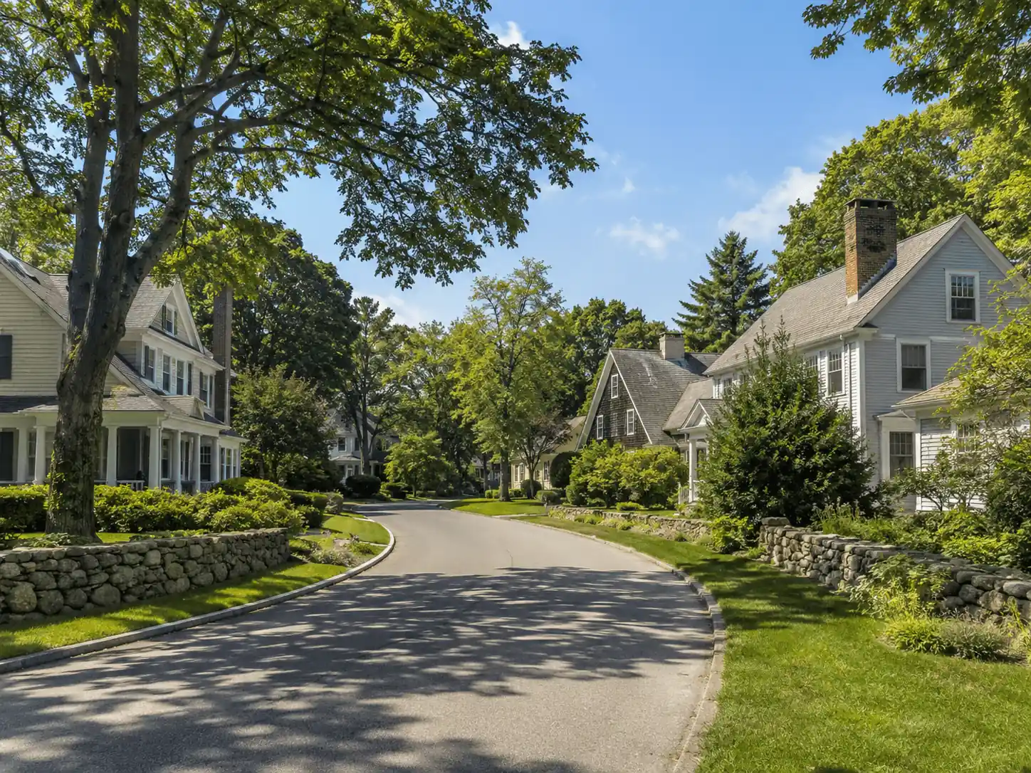 Curved residential street with multiple brick chimneys