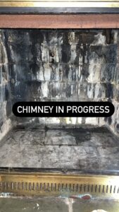 Deteriorated smoke chamber with heavy creosote and soot buildup before repair by TopDog Chimney in Greater Boston