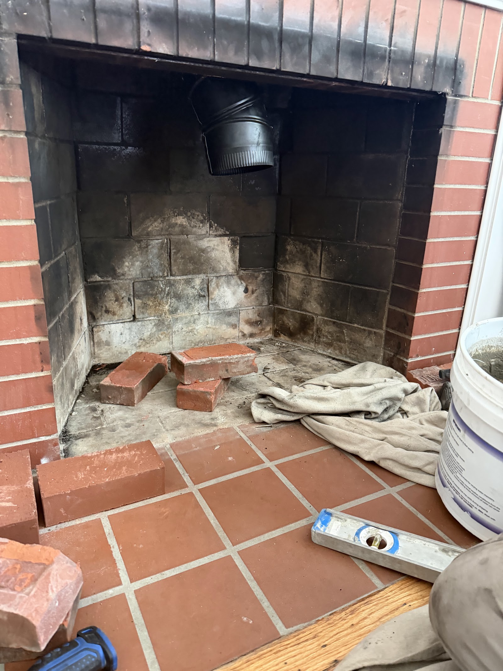 Damaged brick firebox before wood stove insert installation
